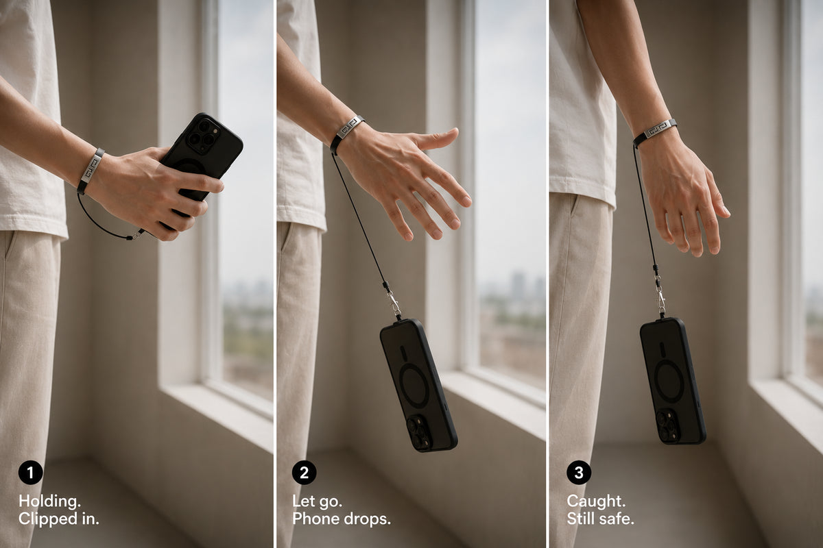 Phone caught dangling on a taut bracelet phone holder tether after being released from an open hand