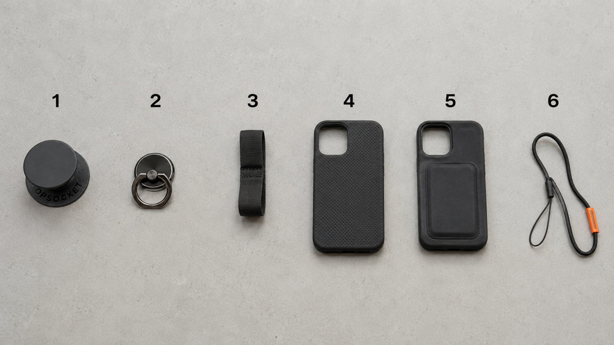 Common types of phone grip used in India laid out together - ring holder, collapsible grip and finger strap