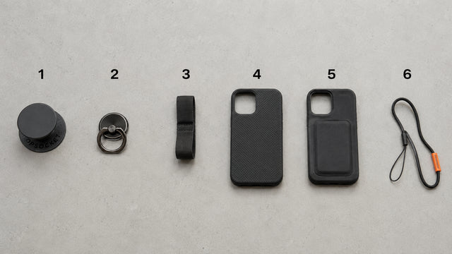 Common types of phone grip used in India laid out together - ring holder, collapsible grip and finger strap