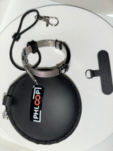 PHLOOP Elite Stainless Steel mesh bracelet with elastic cord and clasp resting on its PHLOOP-branded carry case, beside the tether tab