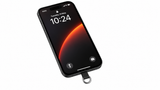 Phone in a black case with the PHLOOP tether tab fitted at the charging port, its metal ring ready for the clasp